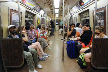 NEW YORK, USA - JULY 4, 2013: People ride Subway train in New York. With 1.67 billion annual rides, New York City Subway is the 7th busiest metro system in the world.のeditorial素材