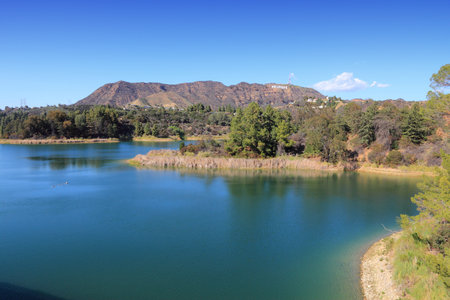 Hollywood Reservoir landscape with small Hollywood sign visible in background.のeditorial素材