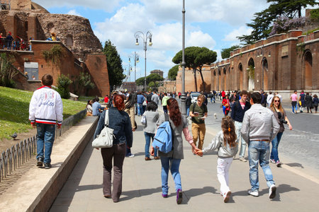 ROME, ITALY - APRIL 10, 2012: Tourists visit Via Fori Imperiali in Rome. According to official data Rome was visited by 12.6 million people in 2013.のeditorial素材