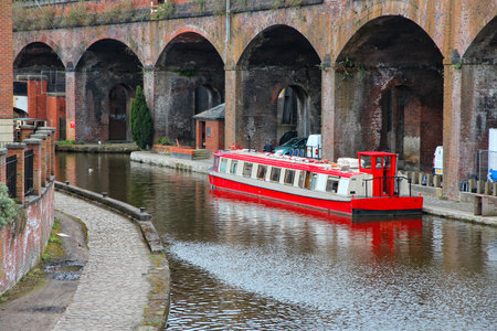 Manchester - city in North West England (UK). Castlefield district, waterway canal area with a narrowboat.のeditorial素材