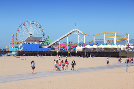 SANTA MONICA, UNITED STATES - APRIL 6, 2014: People visit beach in Santa Monica, California. As of 2012 more than 7 million visitors from outside of LA county visited Santa Monica annually.のeditorial素材