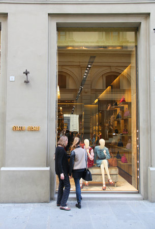 FLORENCE, ITALY - APRIL 30, 2015: People shop at Miu Miu fashion store in Florence. Miu Miu is a part of Prada, company with 3.6 billion EUR of annual revenue (2013).のeditorial素材