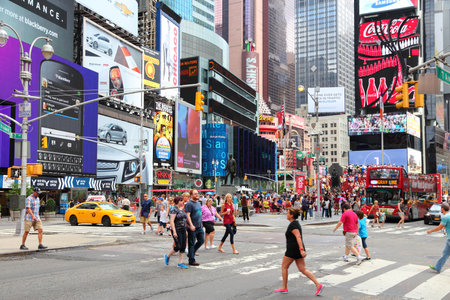 NEW YORK, USA - JULY 4, 2013: Tourists and local people visit Times Square in New York. The square...