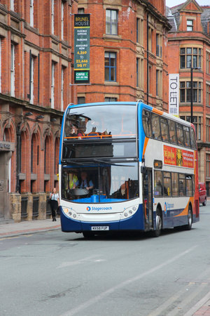 MANCHESTER, UK - APRIL 22, 2013: People ride Stagecoach city bus in Manchester, UK. Stagecoach Group has 16 percent bus market in the UK. Stagecoach UK employs 18,000 people.のeditorial素材