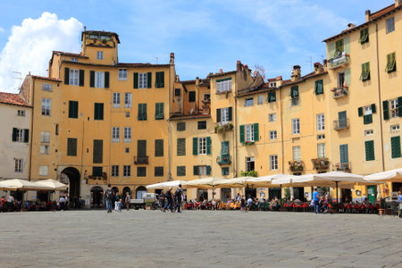 FLORENCE, ITALY - APRIL 29, 2015: People visit Old Town square (Piazza Anfiteatro or Amphitheater Square) in Lucca, Italy. Italy is visited by 47.7 million tourists a year (2013).のeditorial素材