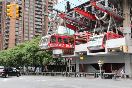 NEW YORK, USA - JULY 3, 2013: People ride Roosevelt Island aerial tramway in New York. More than 26 million passengers have used the tram since it started working in 1976.のeditorial素材