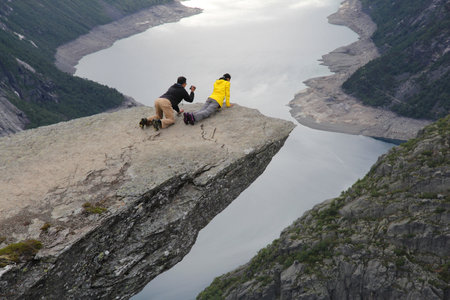 TROLLTUNGA, NORWAY - JULY 16, 2015: People visit Troll's Tongue (Trolltunga) rock in Hordaland county, Norway. The 22km trail to Trolltunga is among most visited in Norway.のeditorial素材