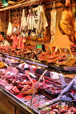 BARCELONA, SPAIN - NOVEMBER 6, 2012: Meat shop at Boqueria market in Barcelona, Spain. The marketplace in Ciutat Vella district dates back to year 1217.のeditorial素材