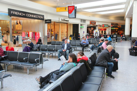 LONDON, UK - APRIL 16, 2014: Passengers wait at London Heathrow Airport in UK. Heathrow is the 3rd busiest airport in the world with 73.4 million passengers handled in 2014.のeditorial素材