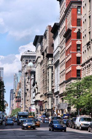 NEW YORK, USA - JULY 5, 2013: People drive the 5th Avenue in New York. New York City is visited by...