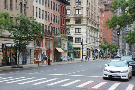 NEW YORK, USA - JULY 1, 2013: People walk along Madison Avenue in New York. Madison Avenue is one of...