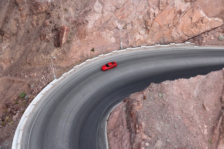 Red sports car on a road curve in Arizona, USA.の写真素材