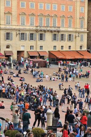 SIENA, ITALY - MAY 3, 2015: People visit Piazza del Campo in Siena, Italy. Siena as a UNESCO World Heritage Site is an important tourism destination in Italy.のeditorial素材
