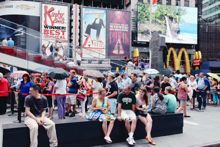 NEW YORK, USA - JULY 3, 2013: Tourists and local people visit Times Square in New York. The square at junction of Broadway and 7th Avenue has some 39 million visitors anually.のeditorial素材