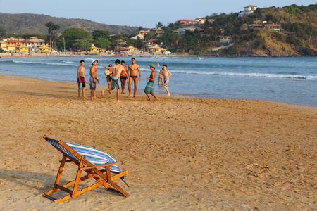 BUZIOS, BRAZIL - OCTOBER 16, 2014: Teenagers play soccer at Geriba beach in Buzios, state of Rio de Janeiro in Brazil. Brazil had 5.17 million visitors in 2012.のeditorial素材