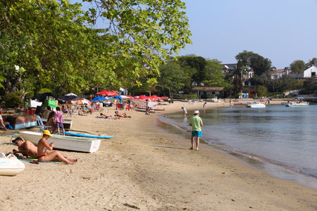 BUZIOS, BRAZIL - OCTOBER 16, 2014: People visit Ferradura beach in Buzios, state of Rio de Janeiro in Brazil. Brazil had 5.17 million visitors in 2012.のeditorial素材