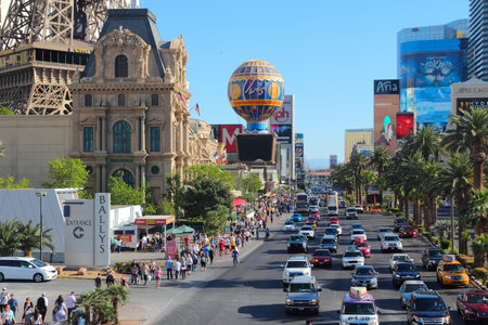LAS VEGAS, USA - APRIL 14, 2014: People visit the famous Strip in Las Vegas. 15 of 25 largest hotels in the world are located at the strip with more than 60 thousand rooms.のeditorial素材