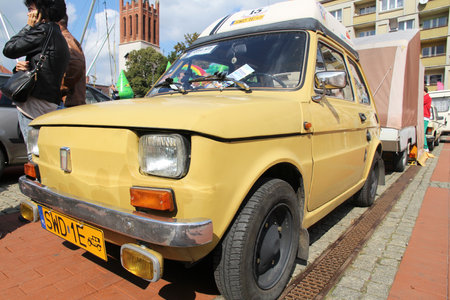 BYTOM, POLAND - SEPTEMBER 12, 2015: People admire Polski Fiat 126p during 12th Historic Vehicle Rally in Bytom. The annual vehicle parade is one of main events of this type in Poland.のeditorial素材