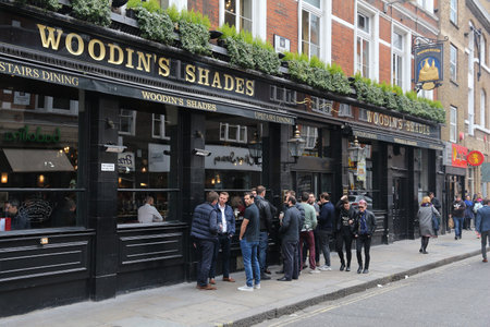 LONDON, UK - APRIL 22, 2012: People visit Woodin's Shades pub in London. It is a typical London pub. There are more than 7,000 pubs in London.のeditorial素材