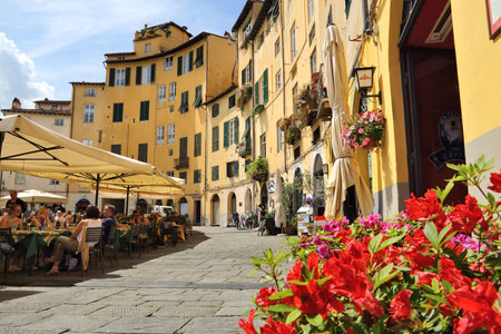 LUCCA, ITALY - APRIL 29, 2015: People visit Old Town square (Piazza Anfiteatro or Amphitheater Square) in Lucca, Italy. Italy is visited by 47.7 million tourists a year (2013).のeditorial素材