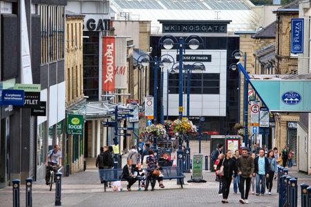 HUDDERSFIELD, UK - JULY 10, 2016: People visit shopping area in Huddersfield, West Yorkshire, UK. Huddersfield is the 11th largest town in the UK with a population of 162,949.のeditorial素材