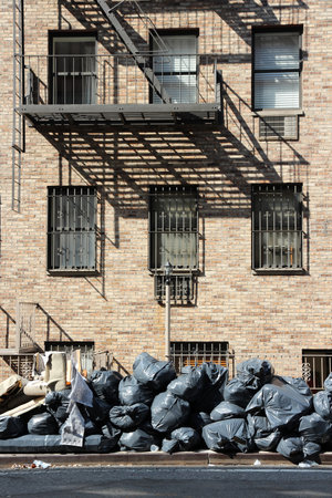 New York garbage bags - household waste waiting for pickup on a Manhattan sidewalk.のeditorial素材