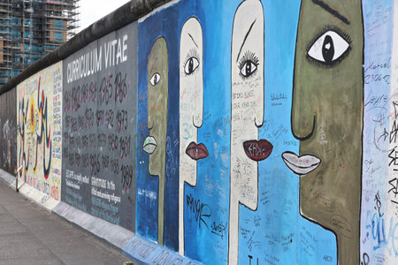 BERLIN, GERMANY - AUGUST 26, 2014: Urban art of East Side Gallery seen from public street in Berlin. Part of former Berlin Wall is covered in art by more than 100 artists since 1990.のeditorial素材