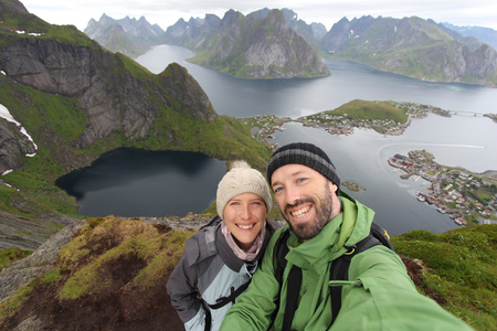 Couple selfie in Norway - hiking vacation view from Reinebringen hiking trail in Lofoten islands.の写真素材