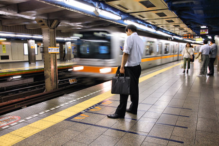 TOKYO, JAPAN - MAY 8, 2012: People wait at Tokyo Metro station in Tokyo. With more than 3.1 billion annual passenger rides, Tokyo subway system is the busiest worldwide.のeditorial素材