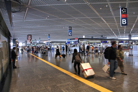TOKYO, JAPAN - MAY 12, 2012: Travelers hurry at Narita International Airport, Tokyo. Narita was the 2nd busiest airport in Japan and 50th busiest worldwide in 2011 with 28.1 million passengers.のeditorial素材