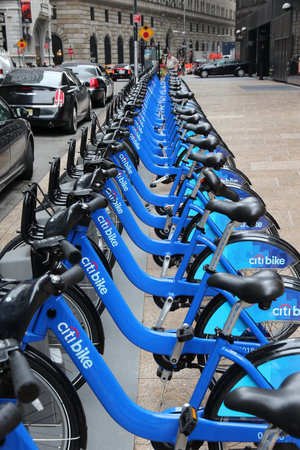 NEW YORK, USA - JULY 2, 2013: Person walks by Citibike bicycle rental station in New York. With 330 stations and 6,000 bicycles it is one of top 10 bike sharing systems in the world.のeditorial素材