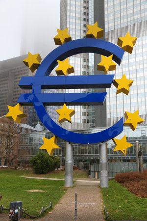 FRANKFURT, GERMANY - DECEMBER 6, 2016: Euro currency sign in front of European Central Bank in downtown Frankfurt, Germany. ECB administers monetary policy of the eurozone.のeditorial素材