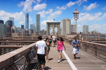 NEW YORK, USA - JULY 5, 2013: People walk along famous Brooklyn Bridge in New York. Almost 19 million people live in New York City metropolitan area.のeditorial素材