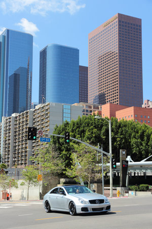 LOS ANGELES, USA - APRIL 5, 2014: Man drives a Mercedes-Benz car in downtown LA. Los Angeles is the 2nd most populous city in the USA (3,792,621 people).のeditorial素材
