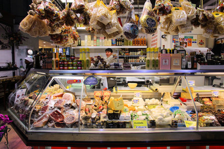 FLORENCE, ITALY - APRIL 30, 2015: Vendor sells cheese at Mercato Centrale market in Florence, Italy. The market is an ultimate Italian shopping experience. It was opened in 1874.のeditorial素材