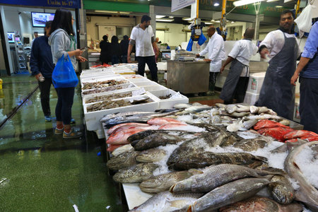 LONDON, UK - JULY 8, 2016: Vendors sell sea food at Billingsgate Fish Market in London, UK. The market is located at Isle of Dogs and is one of largest fish markets in the world.のeditorial素材