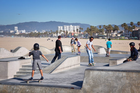 VENICE, UNITED STATES - APRIL 6, 2014: People visit skate park at Venice Beach, California. Venice Beach is one of most popular beaches of LA County. 9.8 million people live in LA County.のeditorial素材