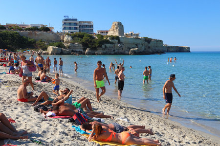 SALENTO, ITALY - JUNE 1, 2017: People visit Torre Dell Orso beach in Salento Peninsula, Italy. With 50.7 million annual visitors Italy is one of the most visited countries.のeditorial素材