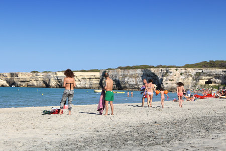SALENTO, ITALY - JUNE 1, 2017: People visit Torre Dell Orso beach in Salento Peninsula, Italy. With 50.7 million annual visitors Italy is one of the most visited countries.のeditorial素材