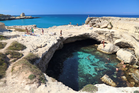 SALENTO, ITALY - JUNE 1, 2017: People visit Grotta Della Poesia swimming cave in Roca, Salento Peninsula, Italy. With 50.7 million annual visitors Italy is one of the most visited countries.のeditorial素材