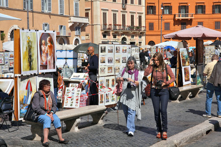 ROME, ITALY - APRIL 10, 2012: Tourists visit Piazza Navona in Rome. According to official data Rome was visited by 12.6 million people in 2013.のeditorial素材