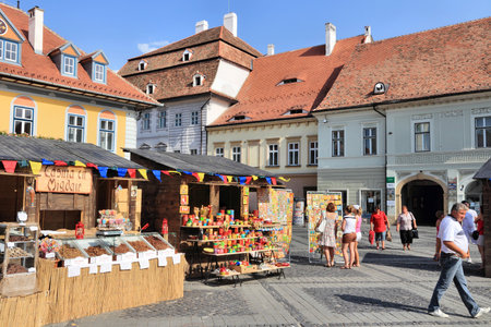 SIBIU, ROMANIA - AUGUST 24, 2012: People visit Piata Mica square in Sibiu, Romania. Sibiu's tourism is growing with 284,513 museum visitors in 2001 and 879,486 visitors in 2009.のeditorial素材