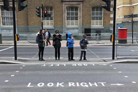 LONDON, UK - APRIL 22, 2016: Children cross the street in London, UK. London is the capital city of United Kingdom and has population of 8.5 million people.のeditorial素材