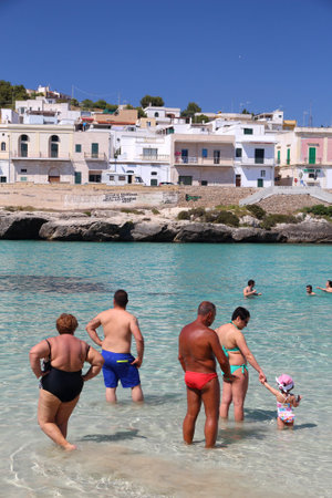 APULIA, ITALY - JUNE 2, 2017: People visit Santa Maria Al Bagno beach in Apulia, Italy. With 50.7 million annual visitors Italy is one of the most visited countries.のeditorial素材