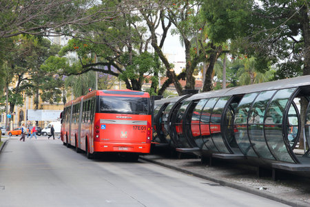 CURITIBA, BRAZIL - OCTOBER 7, 2014: People ride city bus in Curitiba, Brazil. Curitiba's bus system is world famous for its efficiency. Founded in 1974, it serves 2.3 million daily rides.のeditorial素材