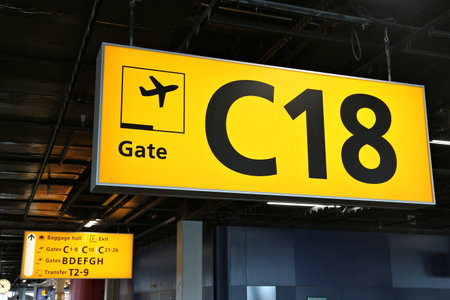 Generic airport signage in Amsterdam. Illuminated gates sign.のeditorial素材