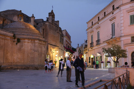 MATERA, ITALY - JUNE 3, 2017: People visit evening Matera, Italy. The Old Town is listed as a UNESCO World Heritage Site.のeditorial素材