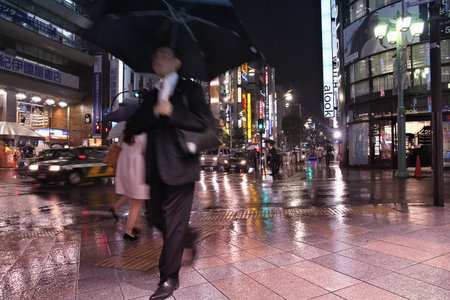 TOKYO, JAPAN - MAY 9, 2012: People shop in the rain in Shinjuku district, Tokyo. Shinjuku is one of special wards of Tokyo. 337,556 people live here.のeditorial素材