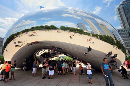 CHICAGO, USA - JUNE 27, 2013: People visit landmark Cloud Gate in Millennium Park in Chicago. With 2.7 million residents, Chicago is the 3rd most populous city in the USA.のeditorial素材