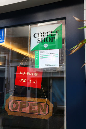 AMSTERDAM, NETHERLANDS - JULY 7, 2017: Legal permit in a window of a coffee shop in Amsterdam, Netherlands. Coffeeshops legally sell marijuana for personal consumption.のeditorial素材